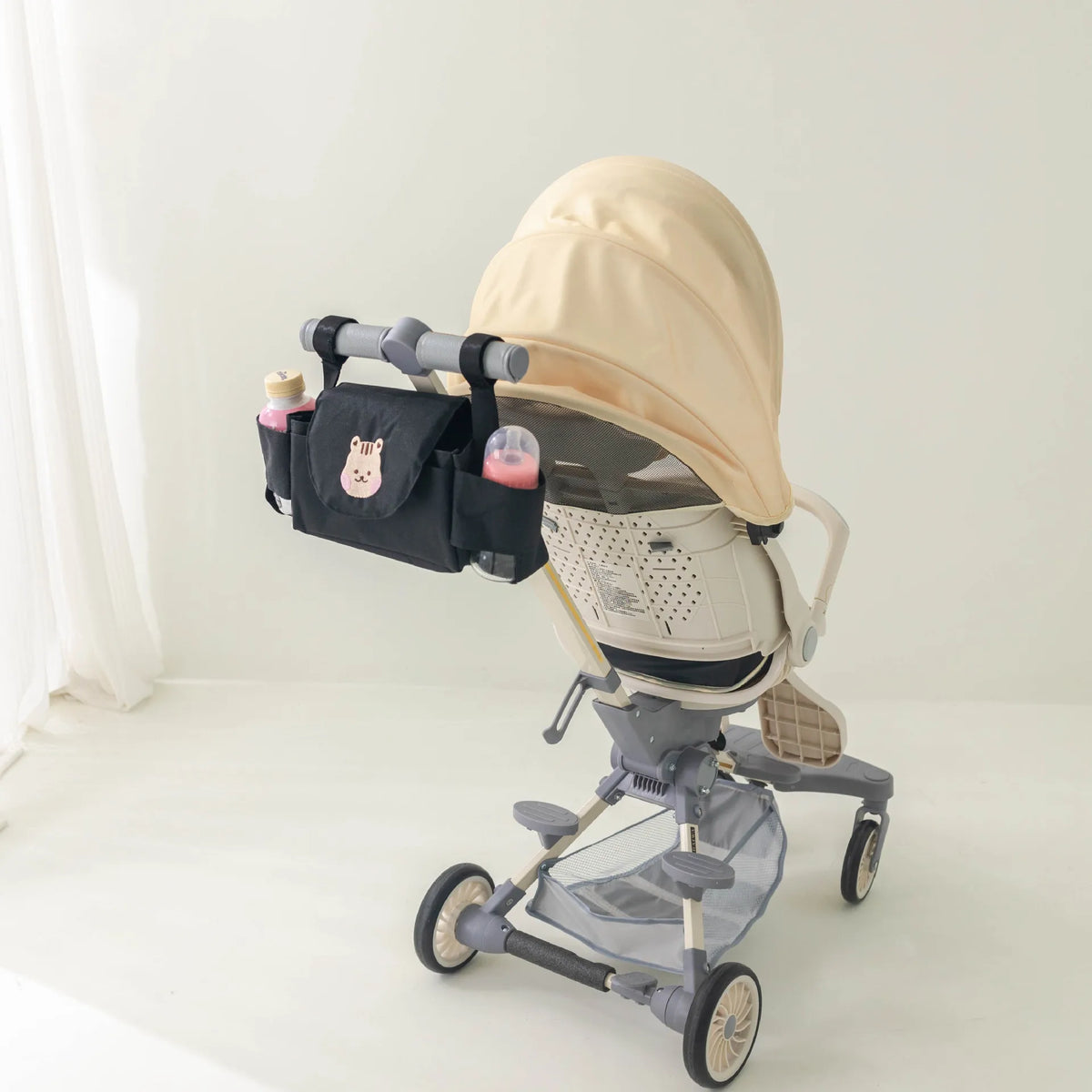 Stroller organizer bag with cup holders on a pram