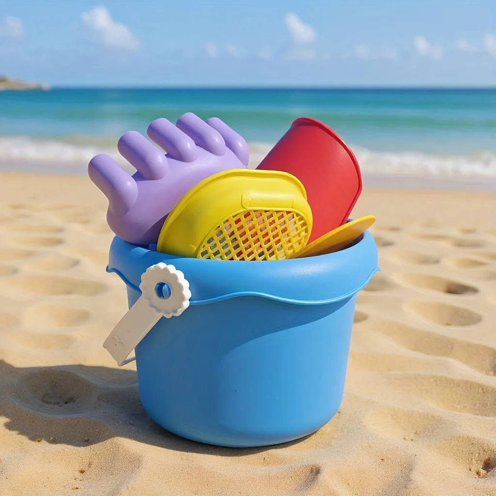 Blue beach bucket with shovels and rake