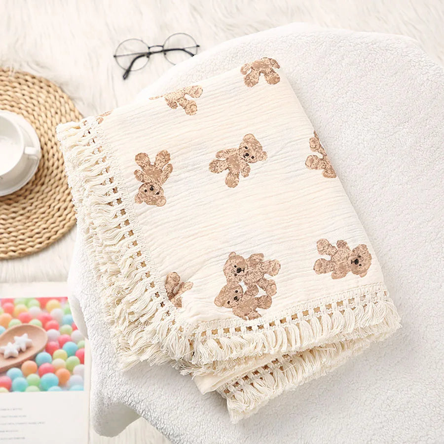 Cute bear muslin cotton baby blanket folded with tassels