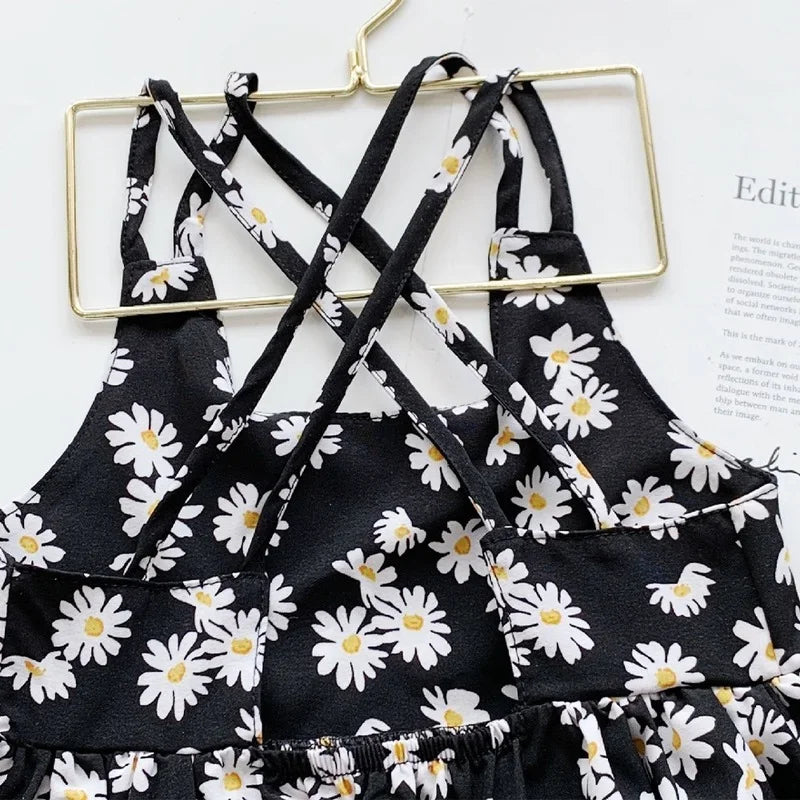 Close-up of cross-back straps and daisy print
