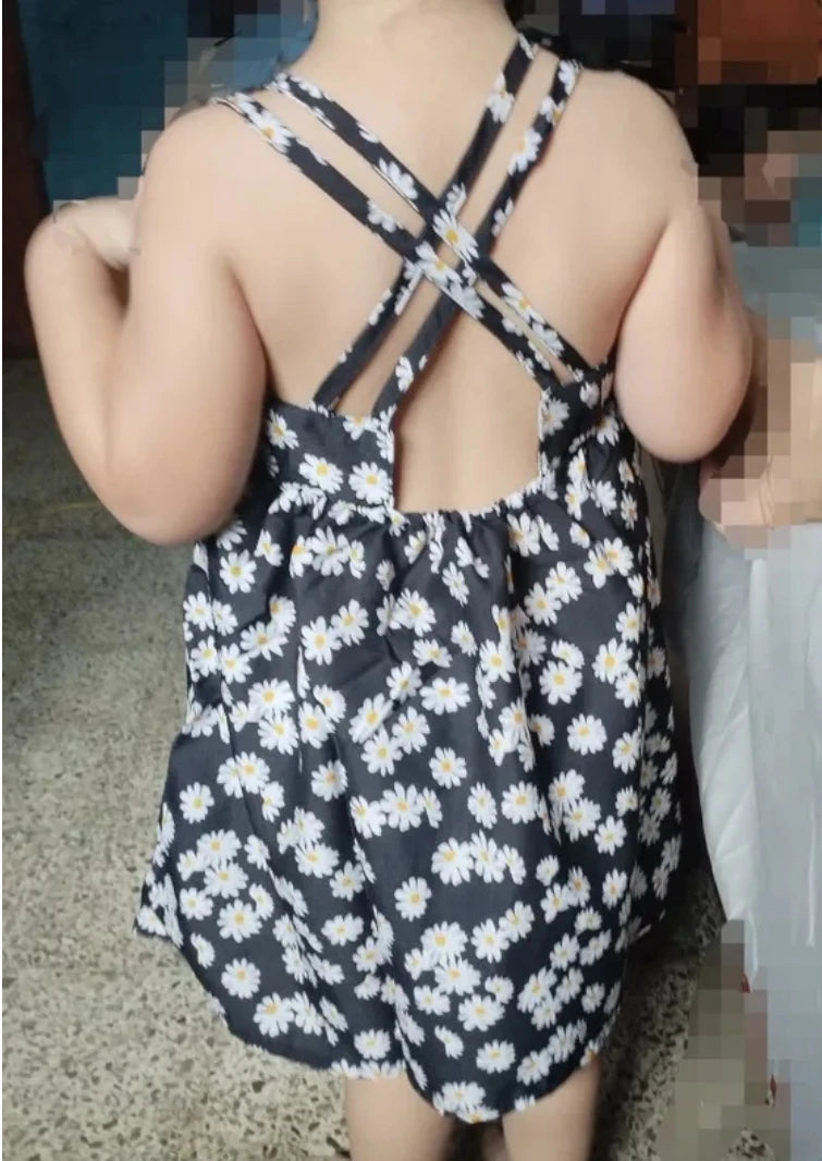 Toddler wearing a daisy print slip dress